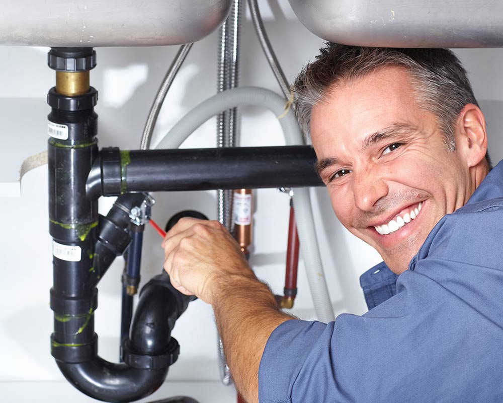 happy plumber repairing sink macomb mi